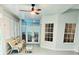 Bright sunroom featuring wicker chairs, ceiling fan, and lots of natural light at 1415 Beach Club, Apollo Beach, FL 33572