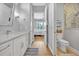 Bathroom with white cabinets, granite countertop with an entrance to another room at 14902 Sweat Loop Rd, Wimauma, FL 33598