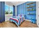 bedroom with blue accents, a large window, and playful decor at 14902 Sweat Loop Rd, Wimauma, FL 33598