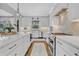 Spacious kitchen with a large island, stainless steel appliances, and herringbone backsplash at 14902 Sweat Loop Rd, Wimauma, FL 33598