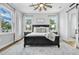 Comfortable primary bedroom with lots of natural light, ceiling fan, and stylish furniture at 14902 Sweat Loop Rd, Wimauma, FL 33598