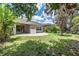 Lush backyard with a manicured lawn and mature trees provides a serene outdoor oasis for relaxation and recreation at 16226 Bayberry View Dr, Lithia, FL 33547
