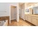 Bathroom with double vanity, granite countertops, and tile floors plus a view to a closet at 16226 Bayberry View Dr, Lithia, FL 33547