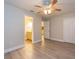 Spacious bedroom features a ceiling fan, wood-look flooring, and an ensuite bathroom, providing a peaceful retreat at 16226 Bayberry View Dr, Lithia, FL 33547