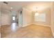 Bright dining area with neutral walls, tile floors, and a contemporary chandelier perfect for gatherings at 16226 Bayberry View Dr, Lithia, FL 33547