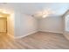 Large living room with wood-look floors, ceiling fan and plenty of natural light from the windows at 16226 Bayberry View Dr, Lithia, FL 33547