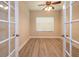 Bright office space featuring wood floors, a ceiling fan, and natural light from a window at 16226 Bayberry View Dr, Lithia, FL 33547