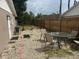 Cozy backyard with a patio set, pea gravel, and a wood fence providing privacy at 192 Tulane Rd, Venice, FL 34293