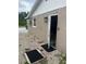 Side exterior view showcasing gravel landscaping and the back entrance at 192 Tulane Rd, Venice, FL 34293