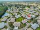 Overhead view of a peaceful neighborhood featuring single-Gathering homes, lush landscaping, and a tranquil pond at 2115 N Halcyon Dr # 510, Sun City Center, FL 33573