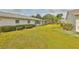Spacious backyard with lush green grass, mature shrubs, offering privacy and charm at 2115 N Halcyon Dr # 510, Sun City Center, FL 33573