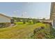 Expansive backyard with green grass, privacy landscaping, and views of neighboring homes at 2115 N Halcyon Dr # 510, Sun City Center, FL 33573