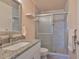 Bathroom with a granite countertop vanity and a glass enclosed shower at 2115 N Halcyon Dr # 510, Sun City Center, FL 33573