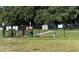 A fenced dog park with a water fountain is surrounded by lush green trees, providing a safe and enjoyable space for pets at 2115 N Halcyon Dr # 510, Sun City Center, FL 33573