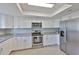 Bright kitchen featuring stainless steel appliances, white cabinets, and granite countertops at 2115 N Halcyon Dr # 510, Sun City Center, FL 33573