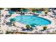 Aerial view of a large outdoor pool area, surrounded by lounge chairs and umbrellas, perfect for relaxation at 2115 N Halcyon Dr # 510, Sun City Center, FL 33573
