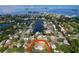 Aerial view of property showcasing lush landscaping, pool, and proximity to waterfront at 232 Pinecrest Dr, Palm Harbor, FL 34683