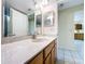 Bathroom includes a modern vanity with marble countertop, framed mirrors, and ceramic tile flooring at 232 Pinecrest Dr, Palm Harbor, FL 34683