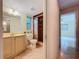 Bathroom featuring a vanity, toilet, window, and glass-enclosed shower with neutral-toned tile at 232 Pinecrest Dr, Palm Harbor, FL 34683
