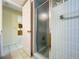 Bathroom featuring a fully-tiled shower with a glass shower door and updated fixtures at 232 Pinecrest Dr, Palm Harbor, FL 34683