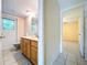 Bathroom featuring a vanity, toilet, and access to the backyard, adjacent to the bedroom at 232 Pinecrest Dr, Palm Harbor, FL 34683