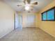 Bedroom features tile floors, ceiling fan, a closet, and a window with blind coverings at 232 Pinecrest Dr, Palm Harbor, FL 34683