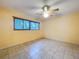 Bedroom with tile flooring, ceiling fan, window with blinds, and neutral paint at 232 Pinecrest Dr, Palm Harbor, FL 34683