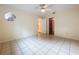 Bright bedroom featuring tile flooring and neutral walls, illuminated by a ceiling fan with a light fixture at 232 Pinecrest Dr, Palm Harbor, FL 34683