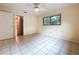 Bedroom with tile floors, ceiling fan and view of outdoor space through window at 232 Pinecrest Dr, Palm Harbor, FL 34683