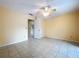 Bedroom features a ceiling fan, neutral paint, and tile flooring at 232 Pinecrest Dr, Palm Harbor, FL 34683