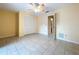 Bedroom features tile flooring, a ceiling fan, neutral paint, and closet space at 232 Pinecrest Dr, Palm Harbor, FL 34683