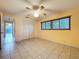 Bedroom featuring tile flooring, ceiling fan, closet space, and window with blinds at 232 Pinecrest Dr, Palm Harbor, FL 34683