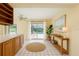 Bright breakfast nook boasts tile floors, direct access to the pool, and custom built-in cabinets at 232 Pinecrest Dr, Palm Harbor, FL 34683
