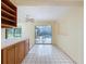 Bright dining area features sliding glass doors to a screened-in pool and white tile flooring at 232 Pinecrest Dr, Palm Harbor, FL 34683