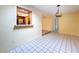 Dining room features a passthrough window to the kitchen and decorative lighting fixture at 232 Pinecrest Dr, Palm Harbor, FL 34683