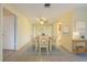 Traditional dining room featuring tan tile floors, wooden table and chairs, and a ceiling fan at 232 Pinecrest Dr, Palm Harbor, FL 34683