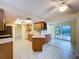 Bright kitchen featuring tile flooring, modern appliances, wooden cabinetry, and an open layout at 232 Pinecrest Dr, Palm Harbor, FL 34683