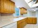 Kitchen featuring white countertops, wood cabinets, and a view of the backyard at 232 Pinecrest Dr, Palm Harbor, FL 34683