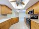 Modern kitchen with stainless steel appliances, natural wood cabinets, and recessed lighting creating a warm atmosphere at 232 Pinecrest Dr, Palm Harbor, FL 34683