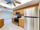 Kitchen with stainless steel appliances, wood cabinets, plenty of lighting, and tile flooring at 232 Pinecrest Dr, Palm Harbor, FL 34683