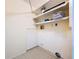 Functional laundry area with tiled floors and storage shelving, ready for customization at 232 Pinecrest Dr, Palm Harbor, FL 34683