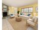 Bright living room features tile floors, stone fireplace, modern furniture, and large windows at 232 Pinecrest Dr, Palm Harbor, FL 34683