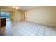 Open layout with tiled floors, connecting to a kitchen, and views of the outdoor pool at 232 Pinecrest Dr, Palm Harbor, FL 34683