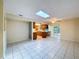 Bright, open living area featuring tiled floors, skylight, and access to the kitchen at 232 Pinecrest Dr, Palm Harbor, FL 34683