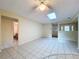Bright, open living area featuring a skylight and convenient access to the bathroom and entry at 232 Pinecrest Dr, Palm Harbor, FL 34683