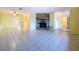 Spacious living room featuring tiled flooring, a stone fireplace, and abundant natural light at 232 Pinecrest Dr, Palm Harbor, FL 34683