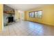 Spacious living room featuring a stone fireplace and large windows for ample natural light at 232 Pinecrest Dr, Palm Harbor, FL 34683