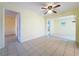 Bright living area with a ceiling fan, tiled floors, and doorway to additional rooms at 232 Pinecrest Dr, Palm Harbor, FL 34683