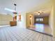 Open living space features natural light, tile flooring, and leads to kitchen at 232 Pinecrest Dr, Palm Harbor, FL 34683