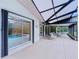 A covered outdoor patio and dining area overlooking a screened pool at 232 Pinecrest Dr, Palm Harbor, FL 34683